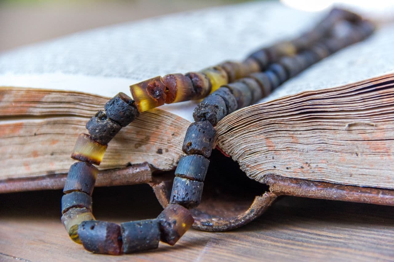 A religious pendant necklace worn around the neck